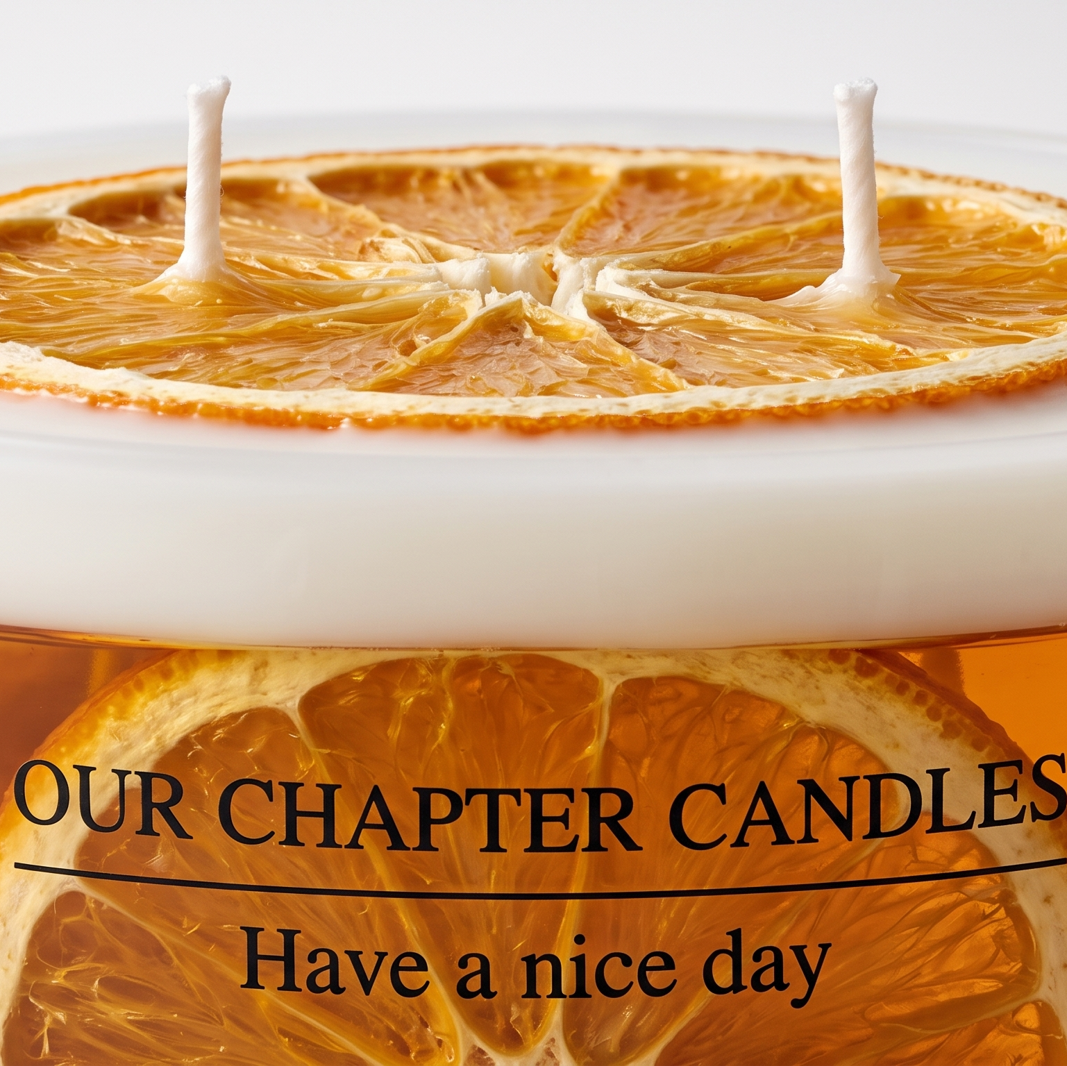 Extreme macro close-up of a botanical candle showing the fibrous texture of a dried orange slice on white wax and embedded citrus fruit in a transparent amber gel wax layer with sharp branded typography.
