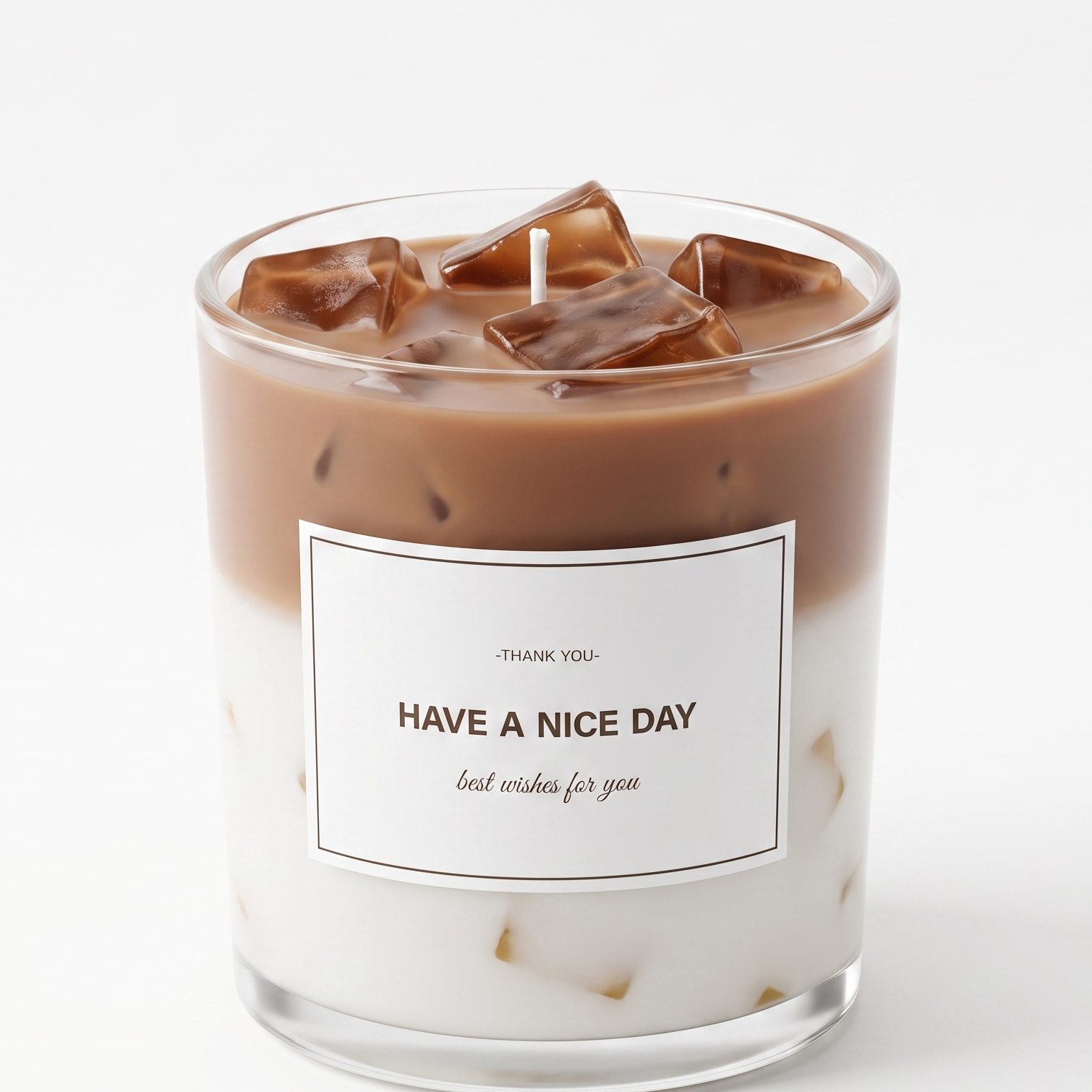 Aesthetic light brown iced coffee latte scented candle inside a clear glass vessel topped with shimmering gel wax ice cubes. Premium beverage-style gift candle with a "THANK YOU" message on a pure white background.