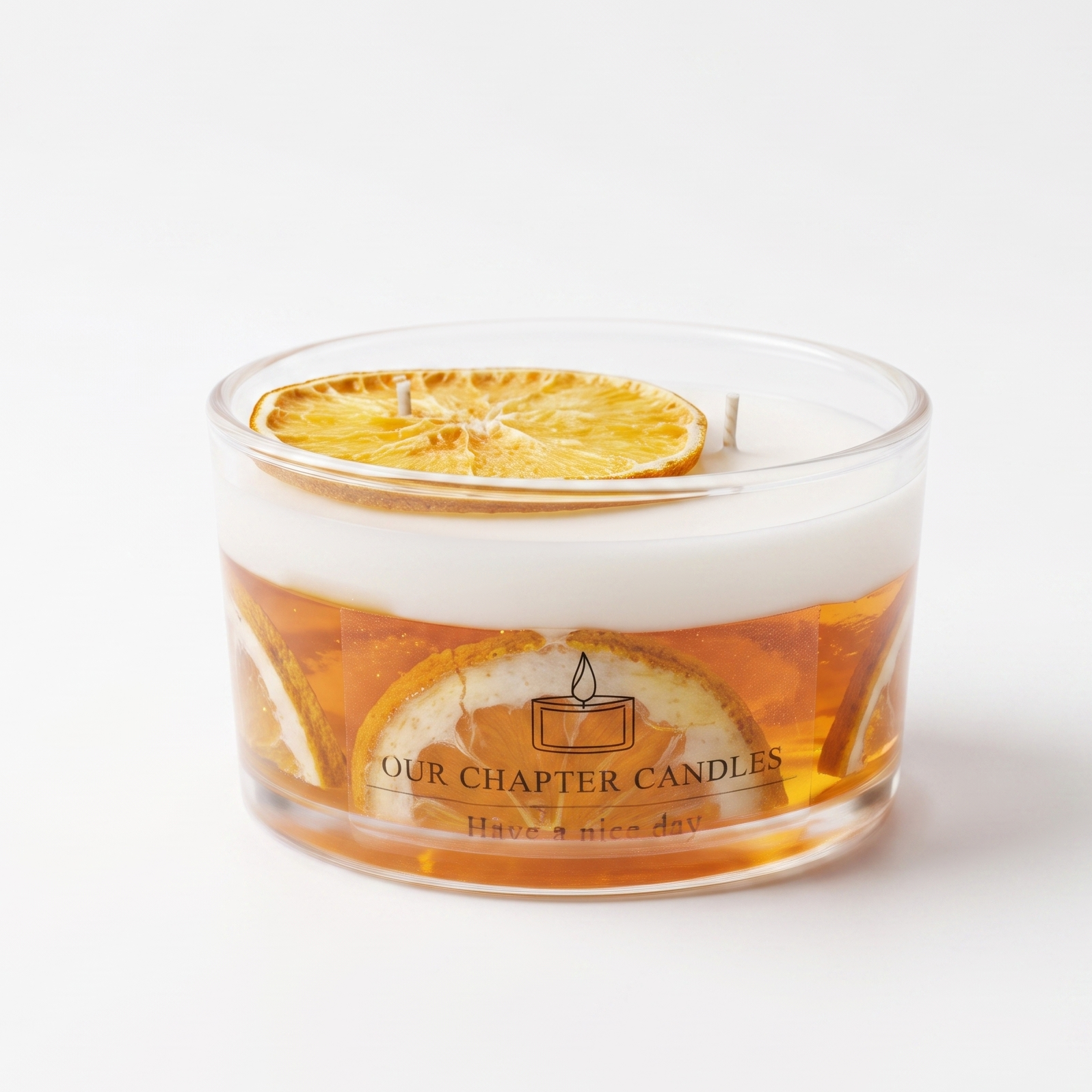 A luxury dual-layer soy and gel wax candle in a clear glass jar with embedded natural dried orange slices. Features a solid white top layer with a dried citrus slice and a transparent amber base on a pure white background.