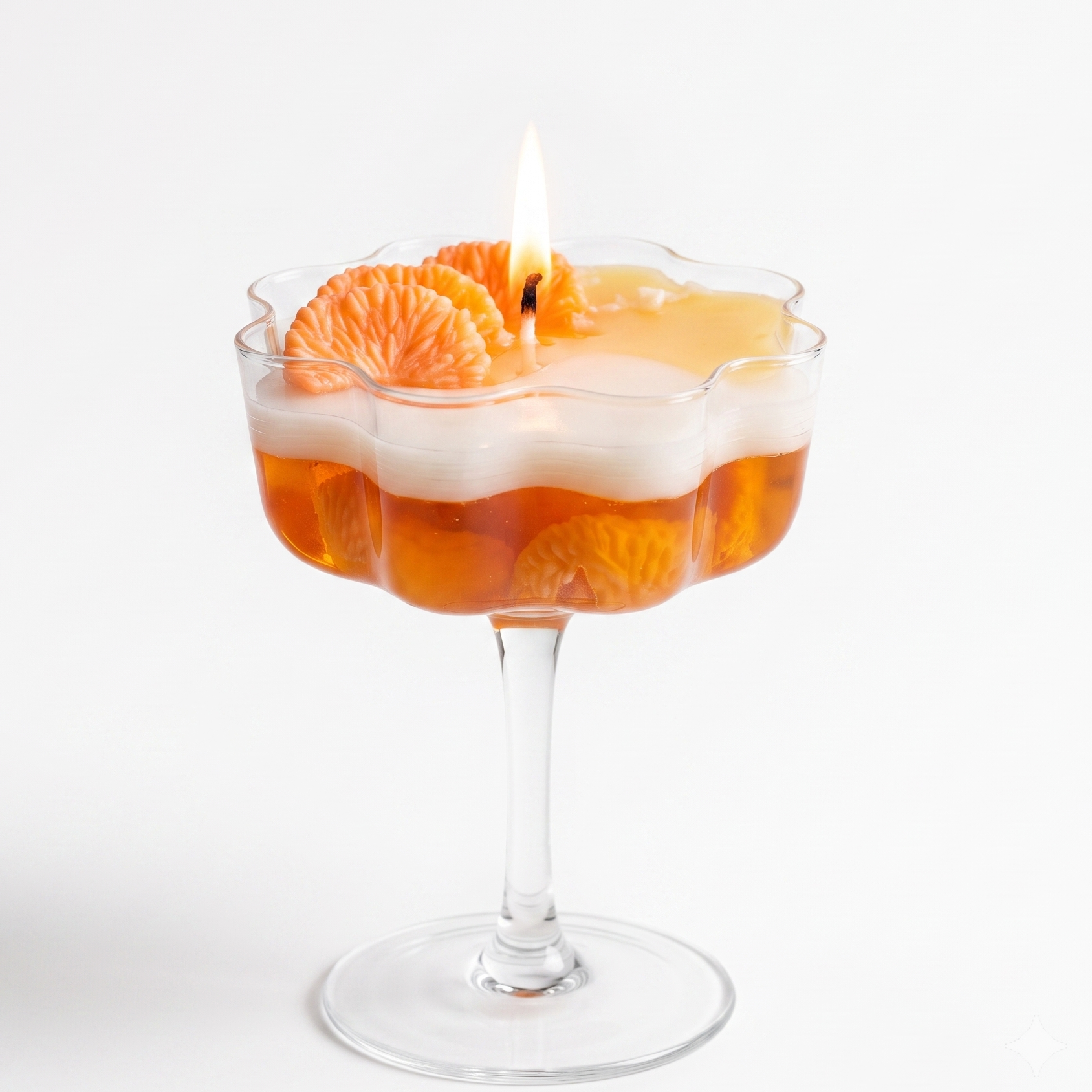 A luxury multi-layered mandarin orange cocktail dessert soy wax candle in a clear petal-rimmed coupe glass based on image_ec1cc5.jpg. Features a translucent amber-orange base, a wavy white soy layer, and realistic top wax citrus segments with a burning flame on a white background.