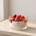 Serene aesthetic lifestyle setting featuring an unlit layered strawberry dessert jar candle on a minimalist travertine table. Clean and bright modern room atmosphere, perfect for premium luxury boutique aromatherapy gifting.