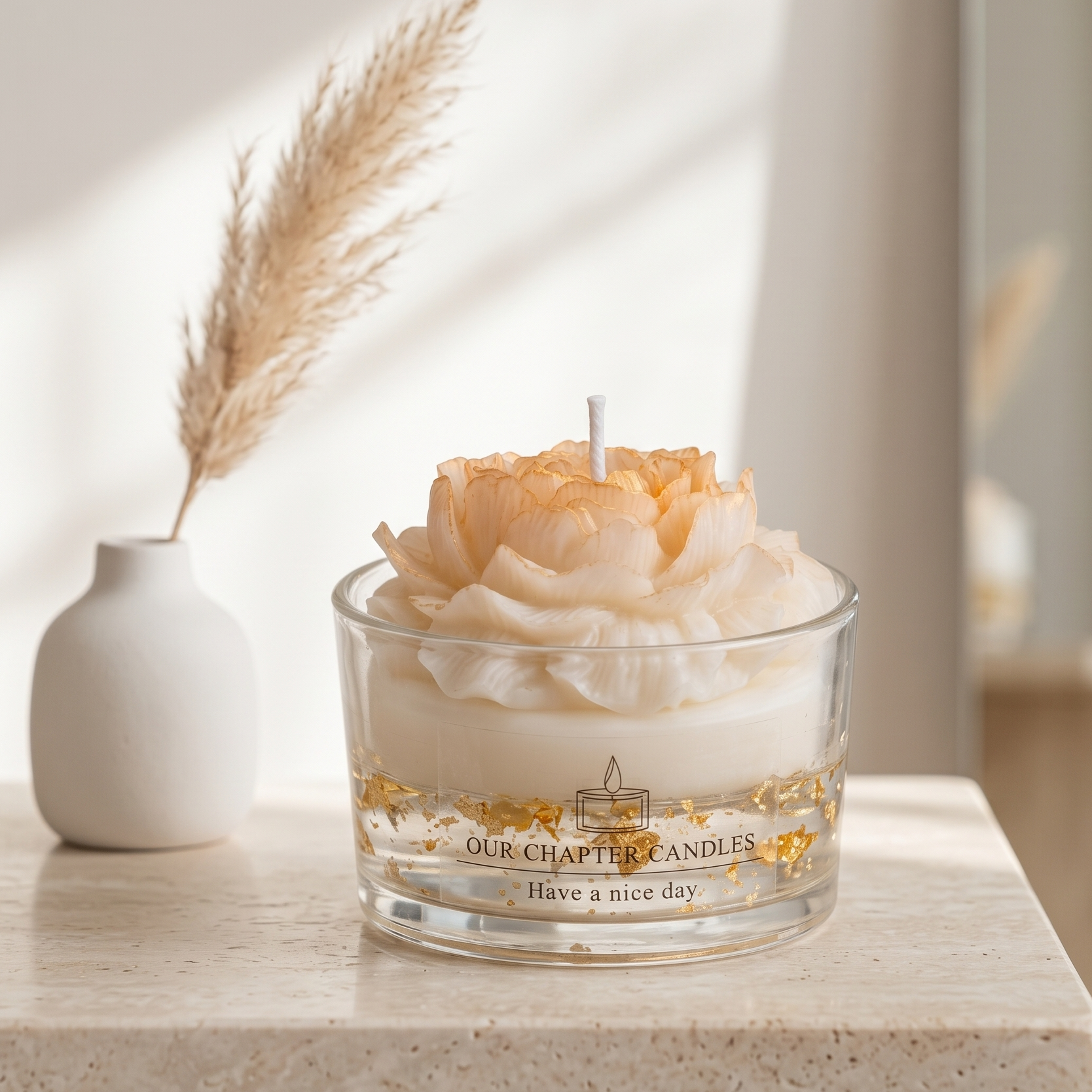 Minimalist home decor lifestyle image with a floral gold-flake candle on a light beige travertine side table. Elegant and serene room setting featuring an aesthetic unlit peony candle, suitable for luxury home fragrance gifts.