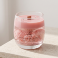 Serene aesthetic lifestyle setting featuring an unlit pink rose jelly jar candle on a minimalist travertine table. Clean and bright modern room atmosphere with soft natural sunlight, ideal for luxury boutique fragrance gifting.