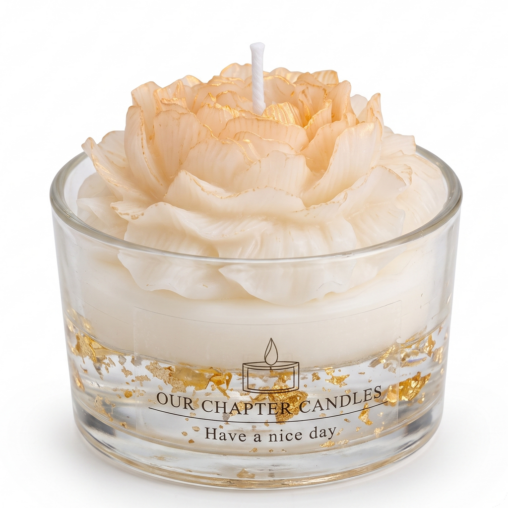 Peony flower shaped luxury soy wax candle in clear glass jar with 24k gold flakes. Transparent base features gold foil text reading "OUR CHAPTER CANDLES - Have a nice day". Premium hand-poured floral scented candle on a pure white background.