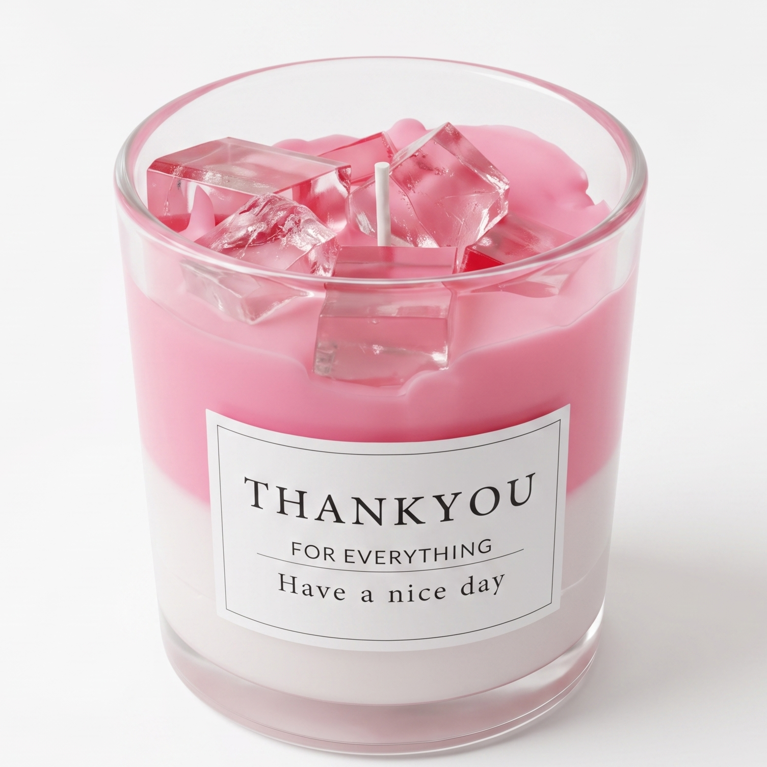 Aesthetic pastel pink strawberry drink-shaped luxury candle with realistic transparent gel wax ice cubes on top. Features a clean white "THANK YOU" gift label in a polished clear glass jar on a white background.