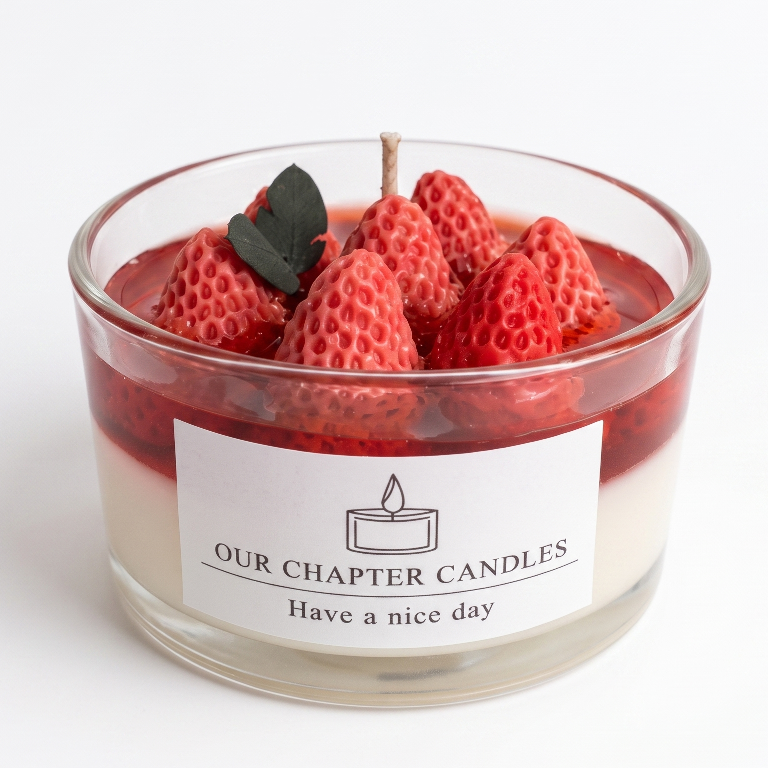 A luxury dual-layer strawberry dessert soy and gel wax candle in a clear glass jar based on image_4656f1.jpg. Features a solid white base, a translucent deep red jelly layer, and a top arrangement of realistic red wax strawberries with a green leaf on a white background.